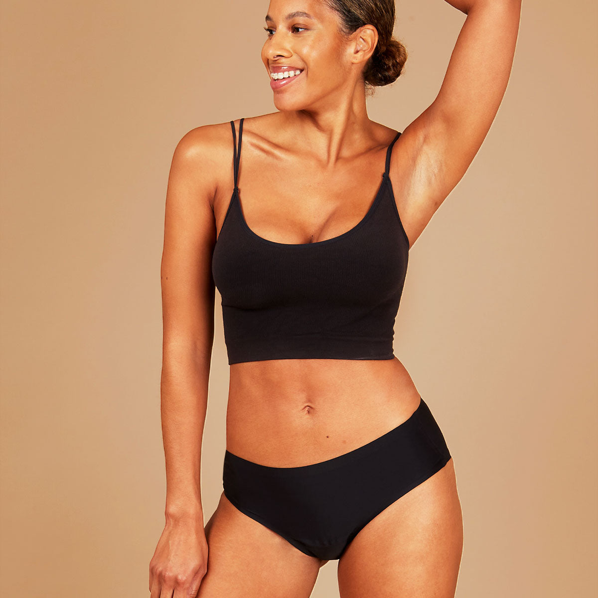 Leakproof seamless period underwear, woman expressing joy.